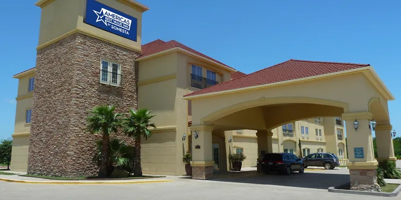 Americas Best Value Inn hotel exterior with a big branded sign on top of the building